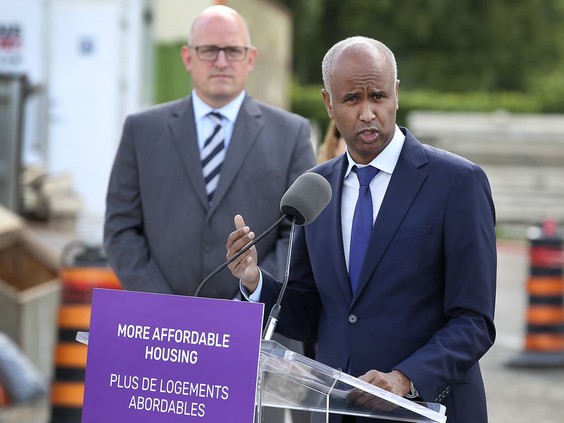 “Housing matters.” Windsor Mayor Drew Dilkens, left, looks on as federal Minister of Families, Children and Social Development Ahmed Hussen speaks in Windsor on Friday. PHOTO BY DAN JANISSE /Windsor Star