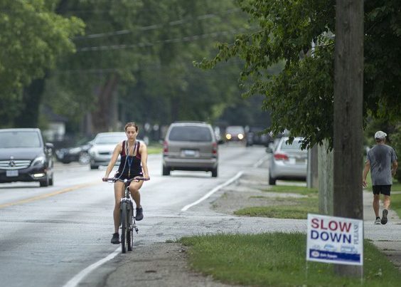A cyclist bikes along Riverside Drive East in Tecumseh, on Friday, Aug. 13, 2021. PHOTO BY DAX MELMER /Windsor Star