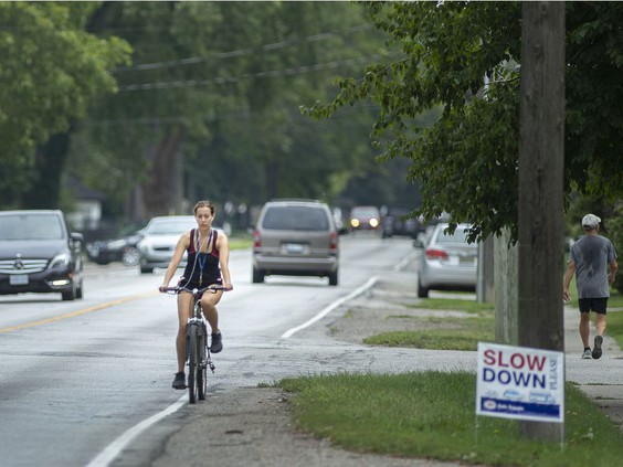 A cyclist bikes along Riverside Drive East in Tecumseh, on Friday, Aug. 13, 2021. PHOTO BY DAX MELMER /Windsor Star